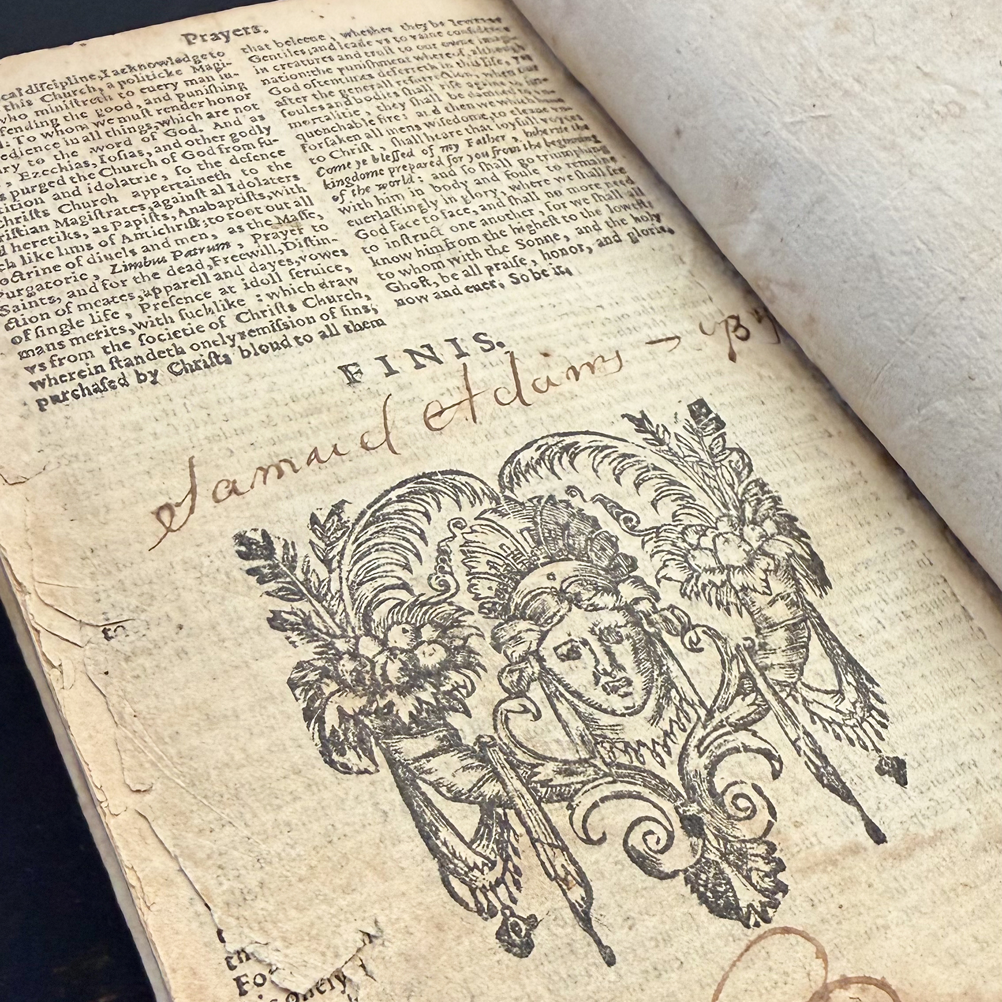 A historic Book of Common Prayer opened to page containing Samuel Adams's signature above an illustration