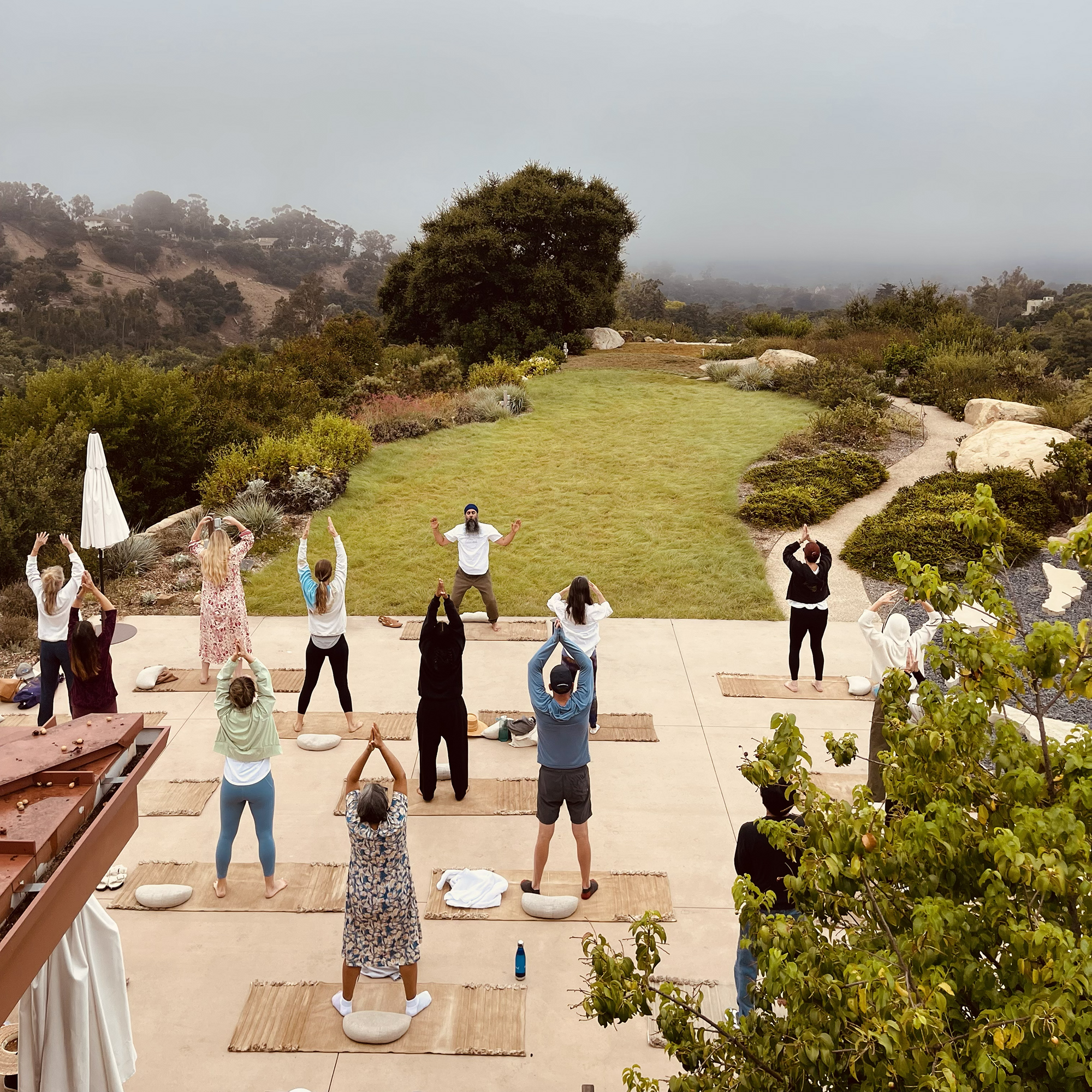 A group practices yoga together, showcasing AmarAtma Singh Khalsa's unique approach to grief care.
