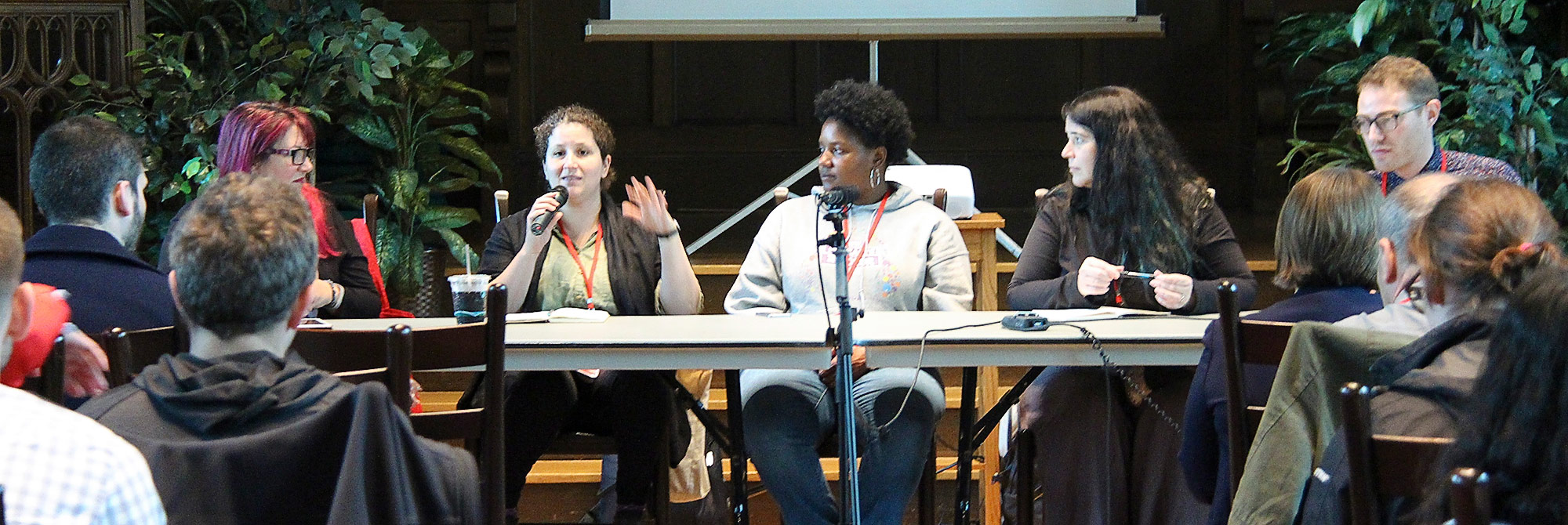 Panelists speaking at a conference