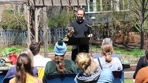 Lutheran minister leading springtime outdoor worship to bless the HDS garden