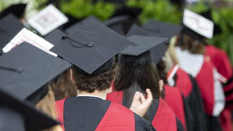 graduates look on during ceremony