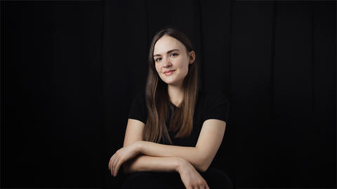 Jenna Carson poses for photo against black backdrop