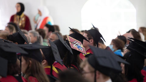 HDS graduates sit in cap and gowns during Commencement