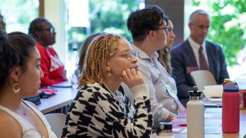 Candice Mulinda , seated, listens to a presentation in the James Room during DivEx 2023