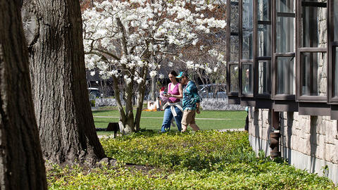 Two students walking across the HDS campus