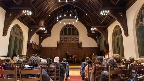 Audience members look ahead during a musical performance in Williams Chapel
