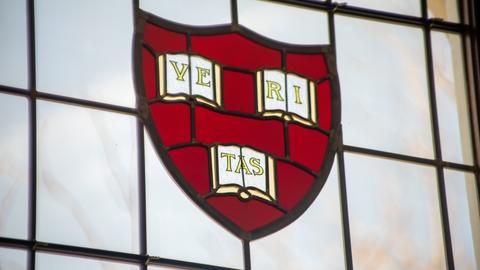 Harvard University shield in stained glass window of Swartz Hall