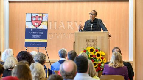 President Claudine Gay stands behind a podium in the James Room speaking to a seated crowd.