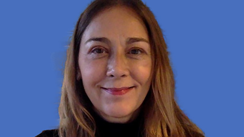 Denise Penizzotto smiles at the camera.