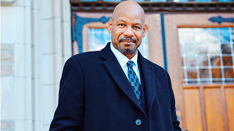 James Lewis stands in front of Swartz Hall