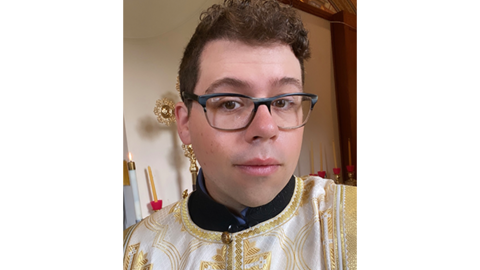 Nicholas in religious garments looking at the camera