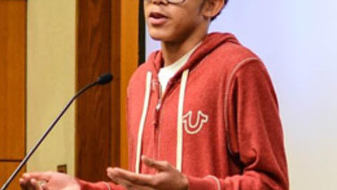 Tay Johnson, youth organizer for the Center for Teen Empowerment, speaks of his experiences to colloquium attendees