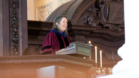 Susan Shallcross Swartz Professor of the Practice of Christian Studies Stephanie Paulsell in academic regalia speaking in Memorial Church