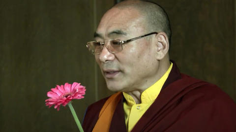 Khentrul Rinpoche holding a flower