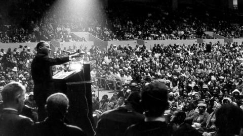 Dr. Martin Luther King, Jr. speaking in front of large crowd