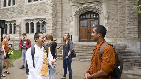Ven. Mahayaye Vineetha, a Buddhist monk (right), and Sadhak Vandan, a visiting Hindu monastic (left), talk outside of the newly renovated Swartz Hall.