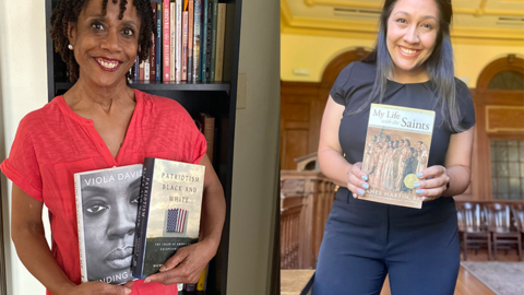 Arleigh Prelow and Clarissa Flores standing facing camera holding books