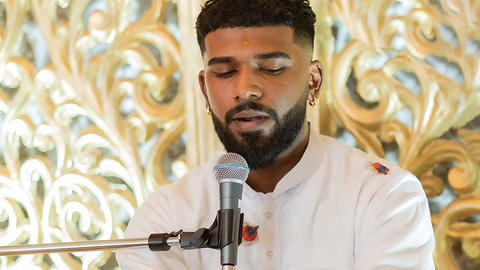 Rajeev Persaud speaking at a microphone