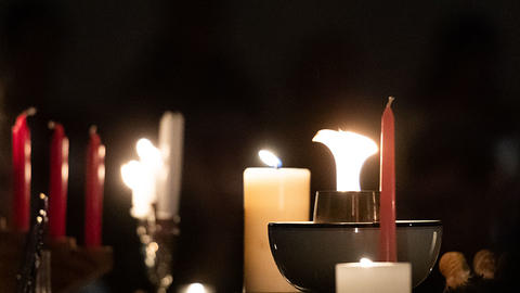 Lit candles and chalice during an HDS community service