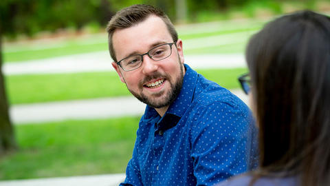 Student support, man smiling.