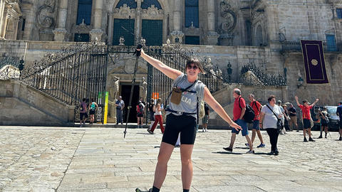 Tssone posing in front of a large stone cathedral