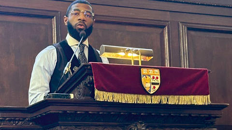Rev. Taylon Lancaster at a lectern