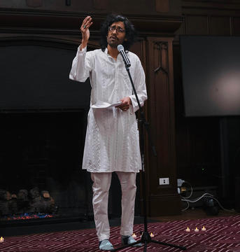 A student speaks from a microphone in the Braun Room