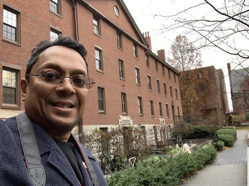 Richard Coutinho, MTS '94, standing outside Divinity Hall