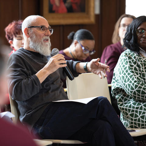 Shaul Magid engages with audience at event with others around him