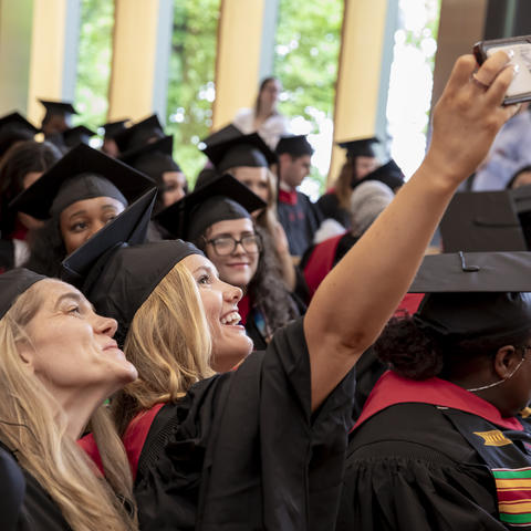Graduates taking a photo in cap and gowns