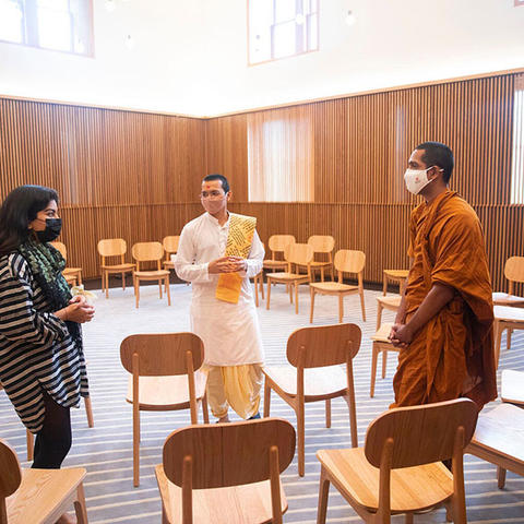 multireligious room in swartz hall with three people standing