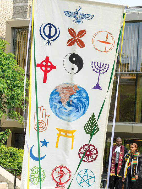 white banner with different religious symbols covering it