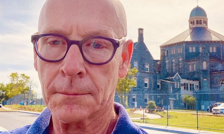 Ed Shea stands before the prison system where he worked in the summer of 2026