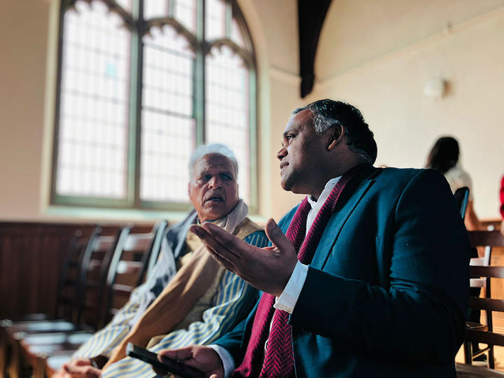 Two individuals converse in the Williams Chapel