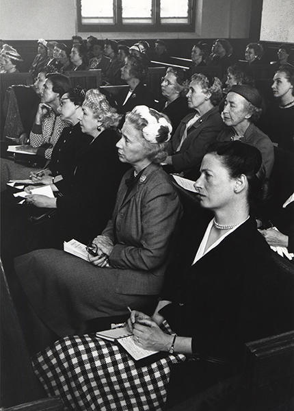 Women seated in rows of pews