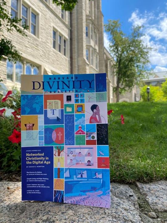 A copy of Harvard Divinity Bulletin in front of Swartz Hall