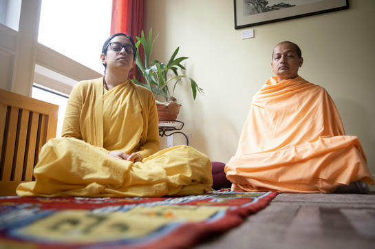 Monastics pray in meditation rooms