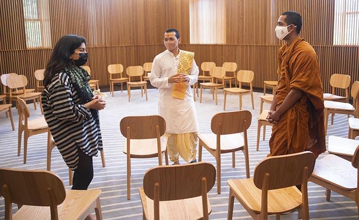 In HDS's Swartz Hall, Sadhak Vandan (center), meets in the new Multifaith Space with student Minahil Mead (left) and student and Buddhist monk Mahayaye Vineetha
