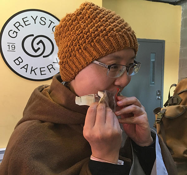 Ven. Xianfeng Shi munches on a Greyston Bakery brownie.