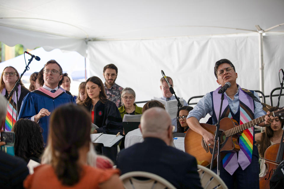 a group plays instruments and sings during a commencement service