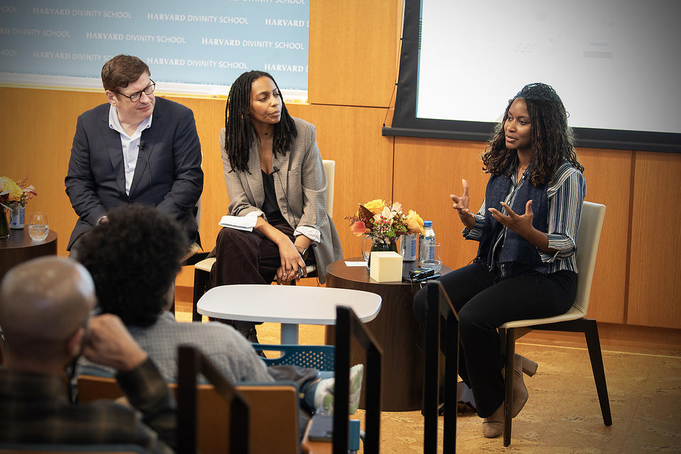 Kurt Keilhacker, Nikki Hoskins, and Etosha Cave sit in a row and speak with each other, showing the dialogue that took place during the event