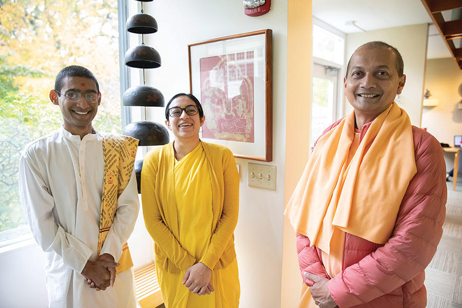 Three monastics smiling at the camera