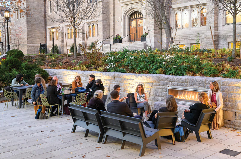 HDS Alumni sitting near the fireplace on the HDS Terrace