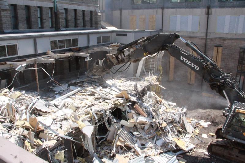 Construction vehicle demolishing Swartz Hall cloister link