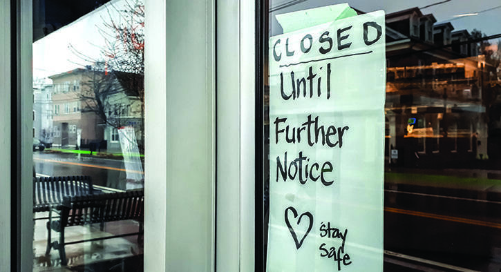 Stay Safe sign in window of closed store