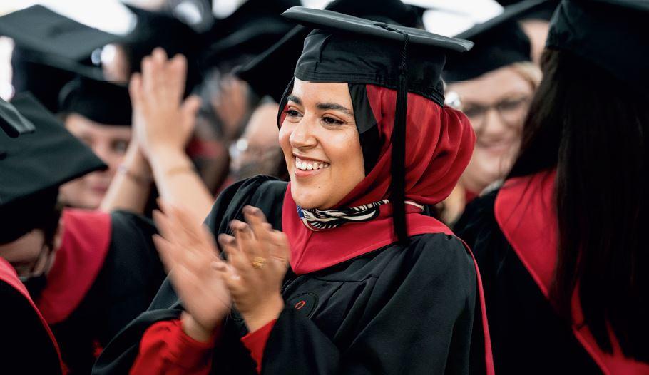 A student clapping during Commencement