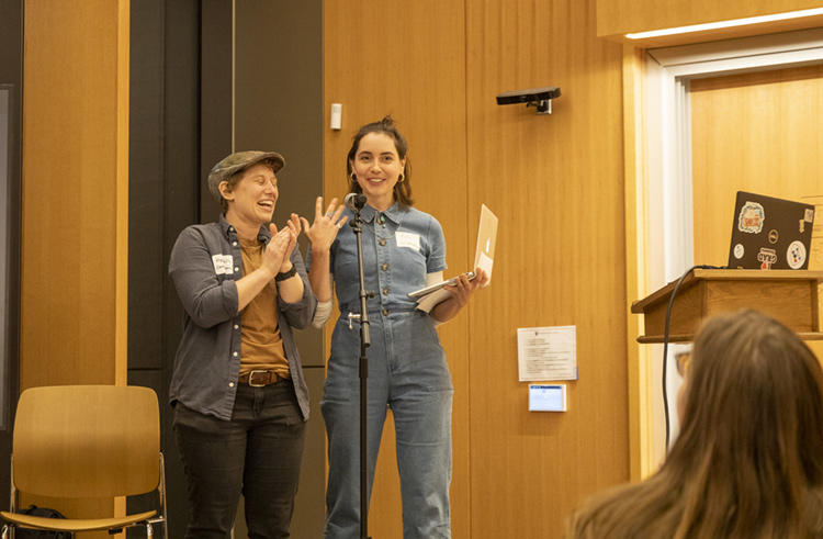 Two HDS students speaking at a microphone