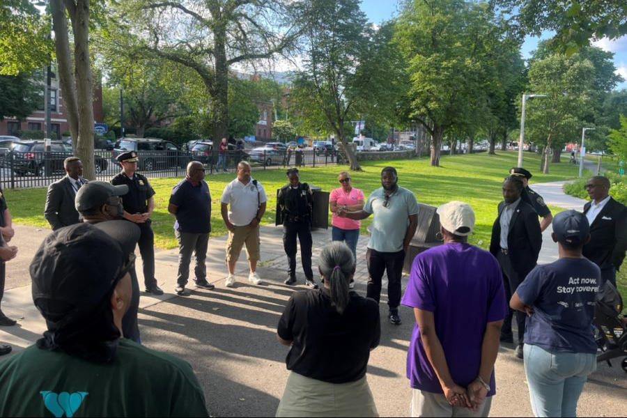 A circle of people outside at a park.