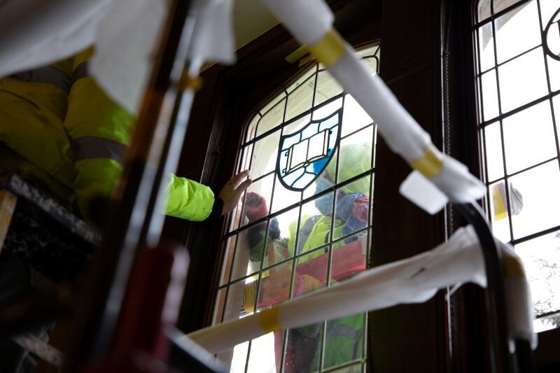 Installation of stained glass in Braun Room