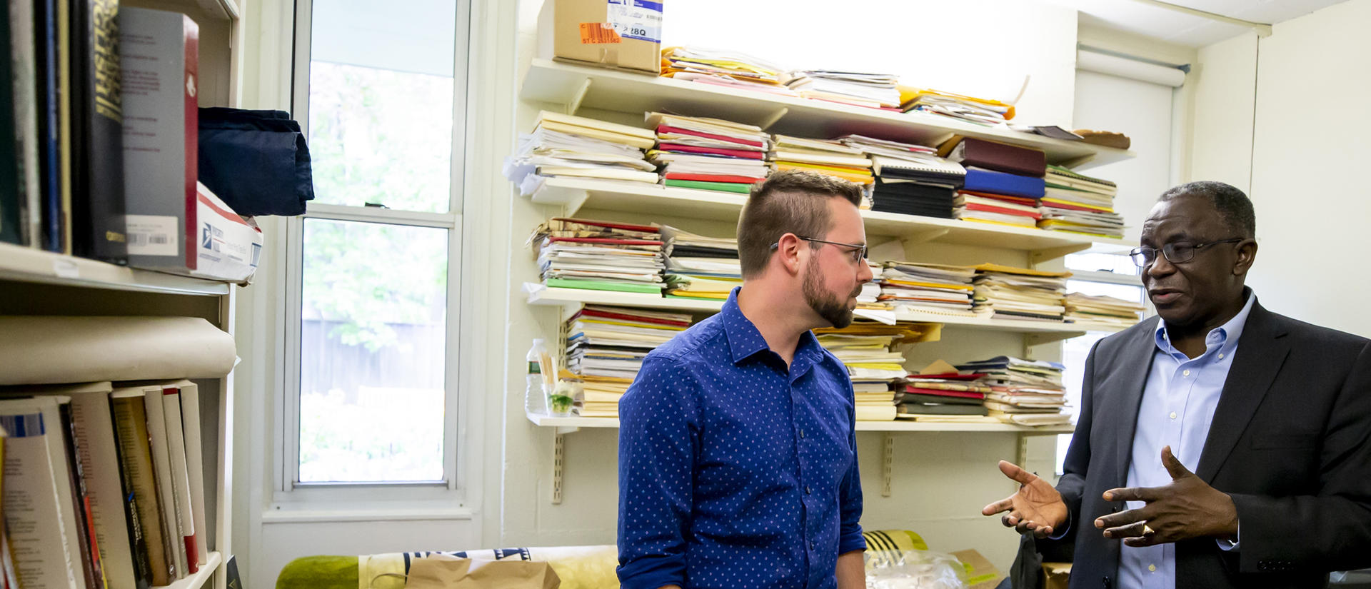 HDS student meeting with a professor in his office